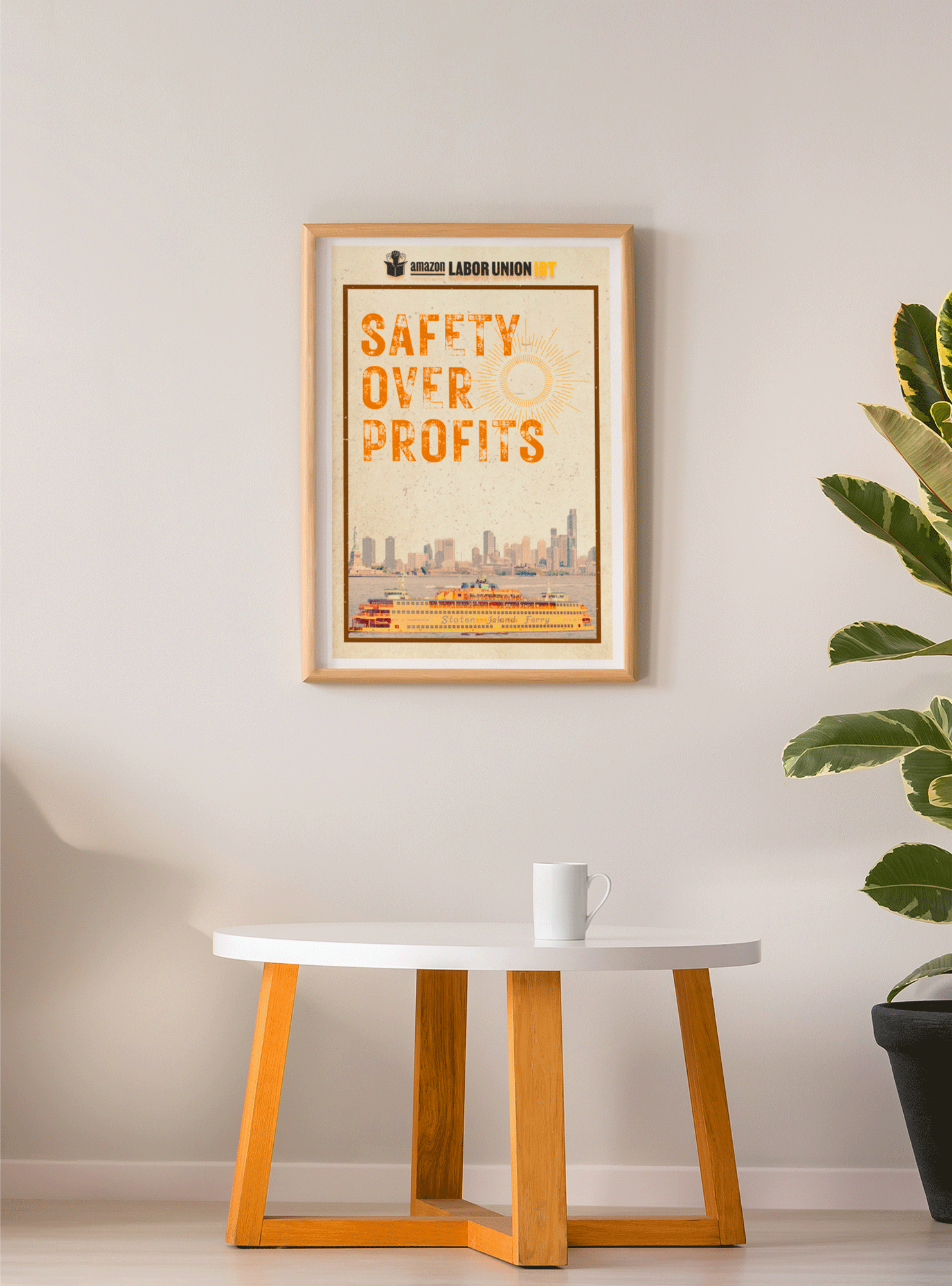 Framed poster with 'Safety Over Profits' text on a wall above a table.