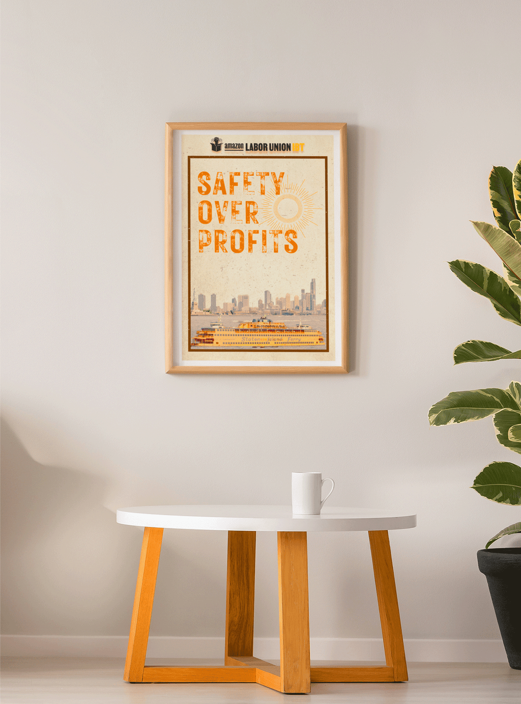 Framed poster with 'Safety Over Profits' text on a wall above a table.