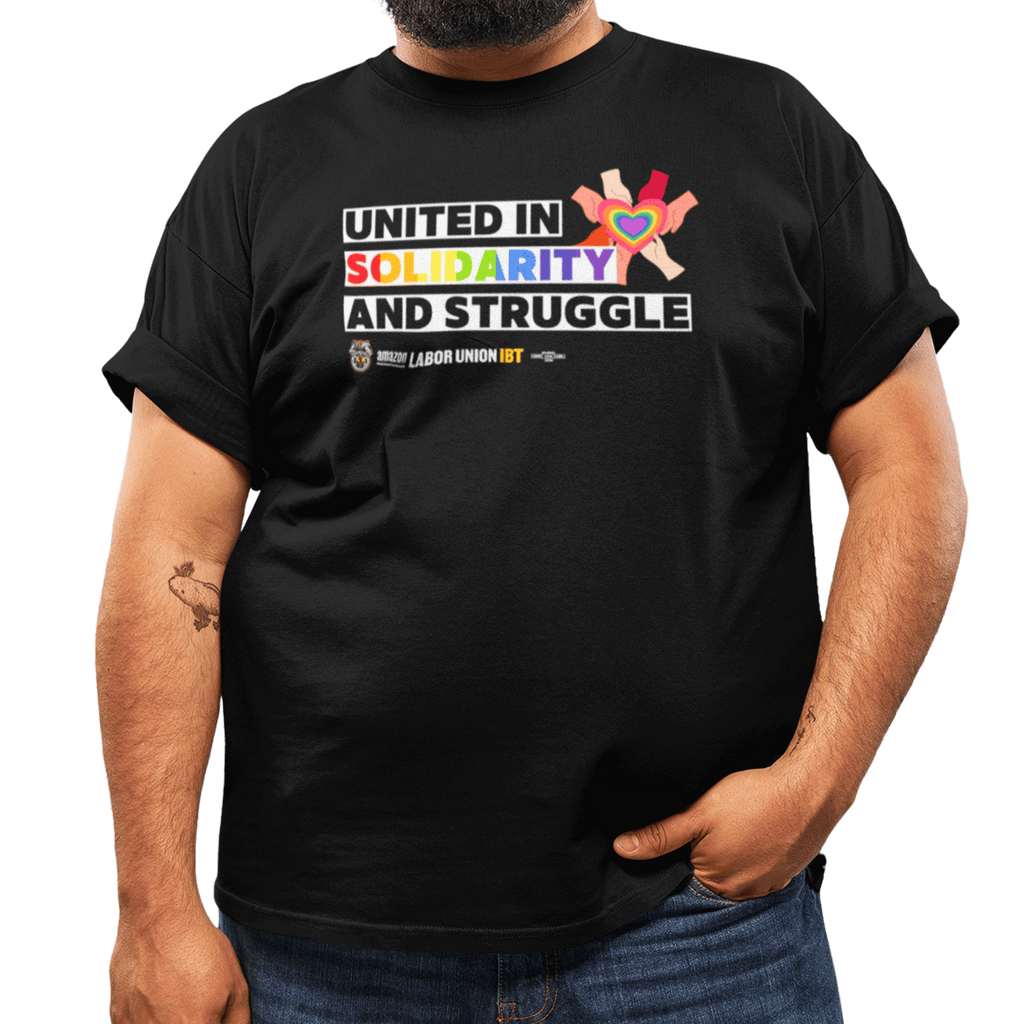 Person wearing a black t-shirt with colorful text and graphics on a white background